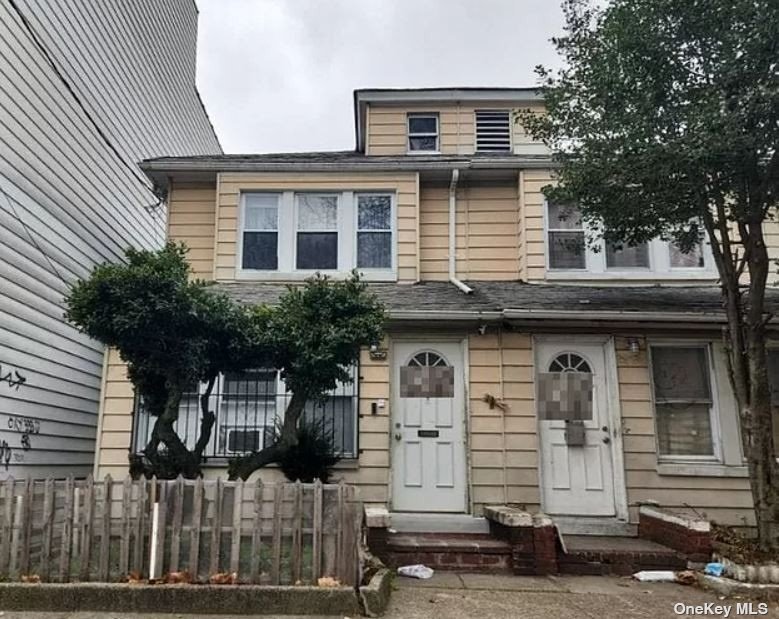 a front view of a house with garage