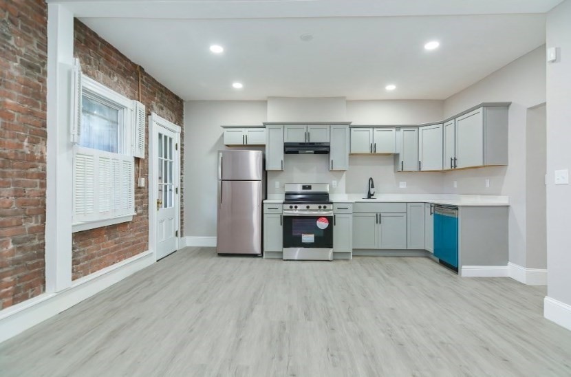 a kitchen with stainless steel appliances a refrigerator and a sink