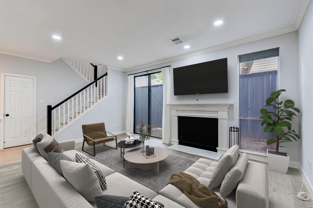 a living room with furniture a flat screen tv and a fireplace