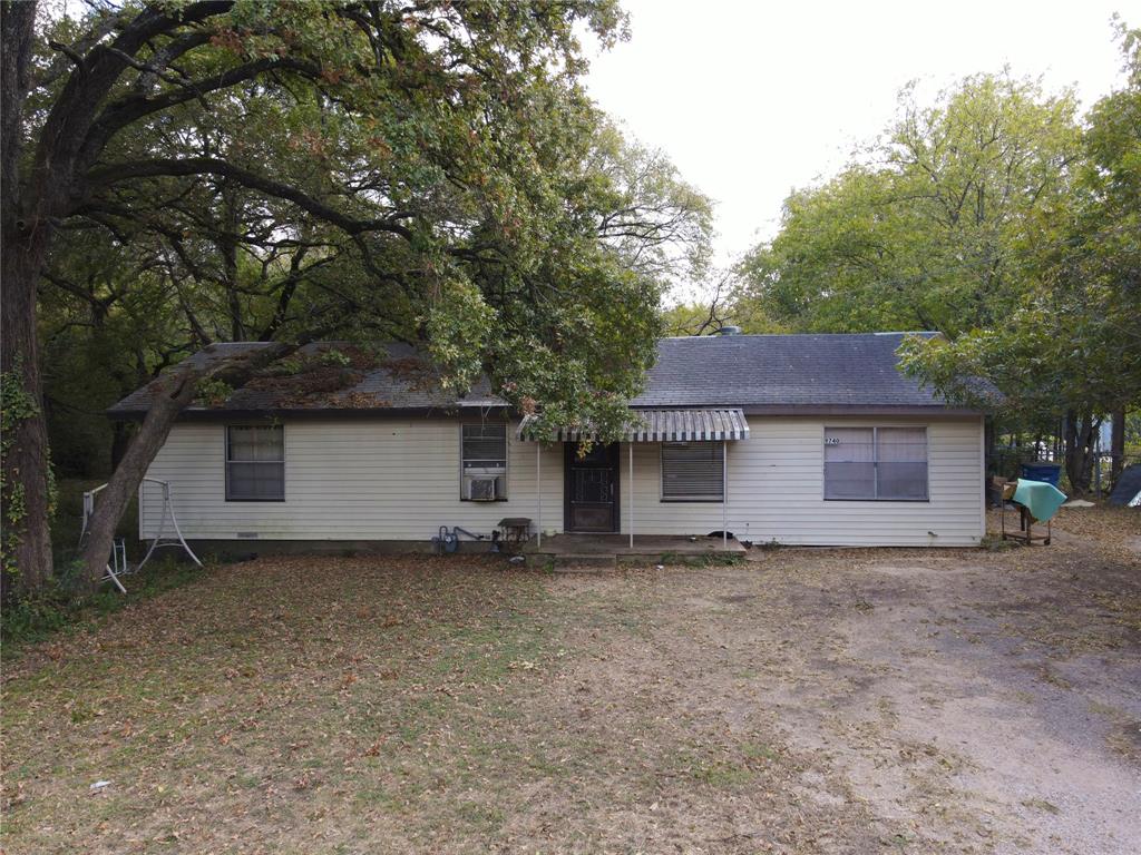 a house that has a tree in front of it