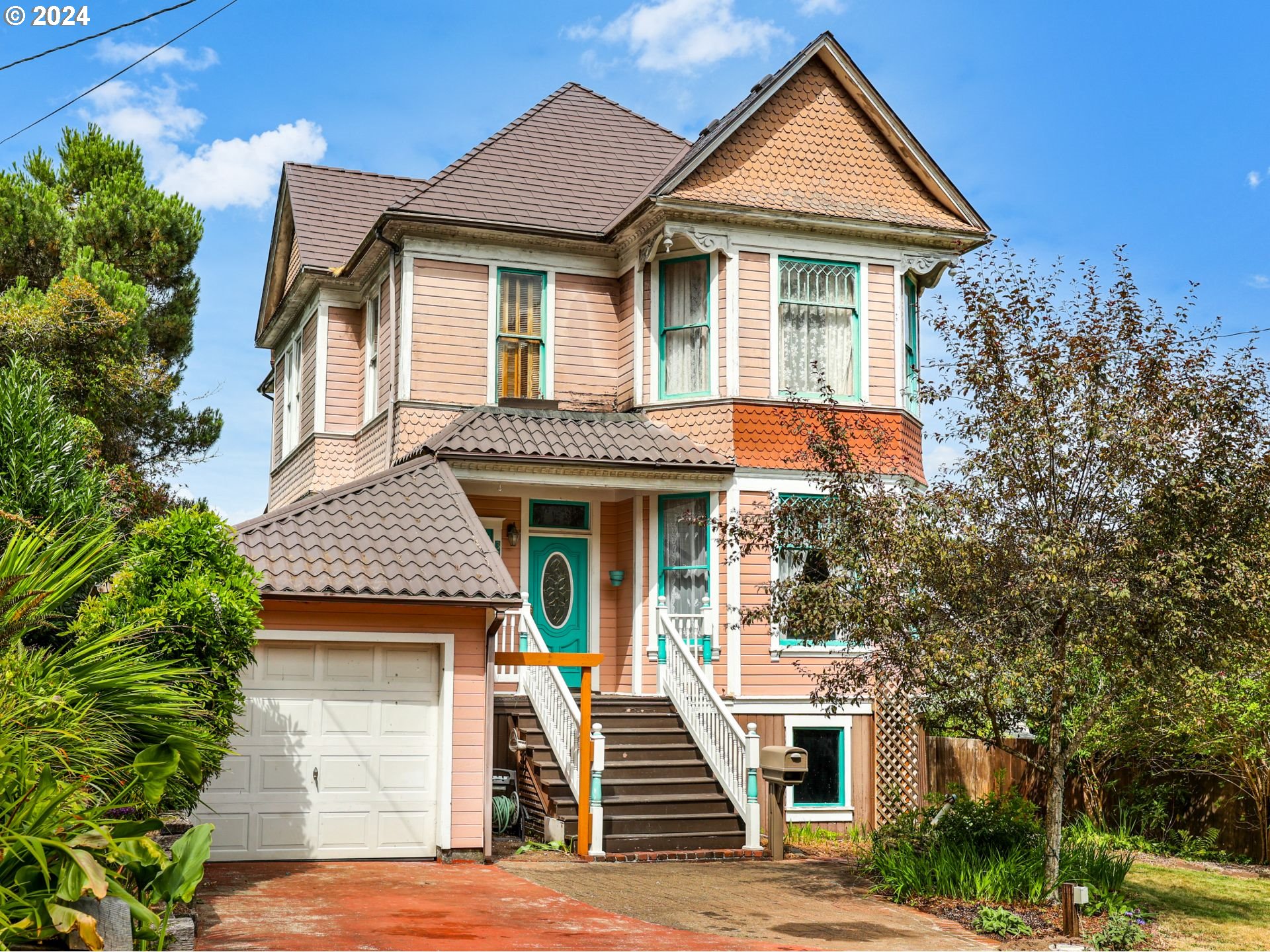 a front view of a house with a garden