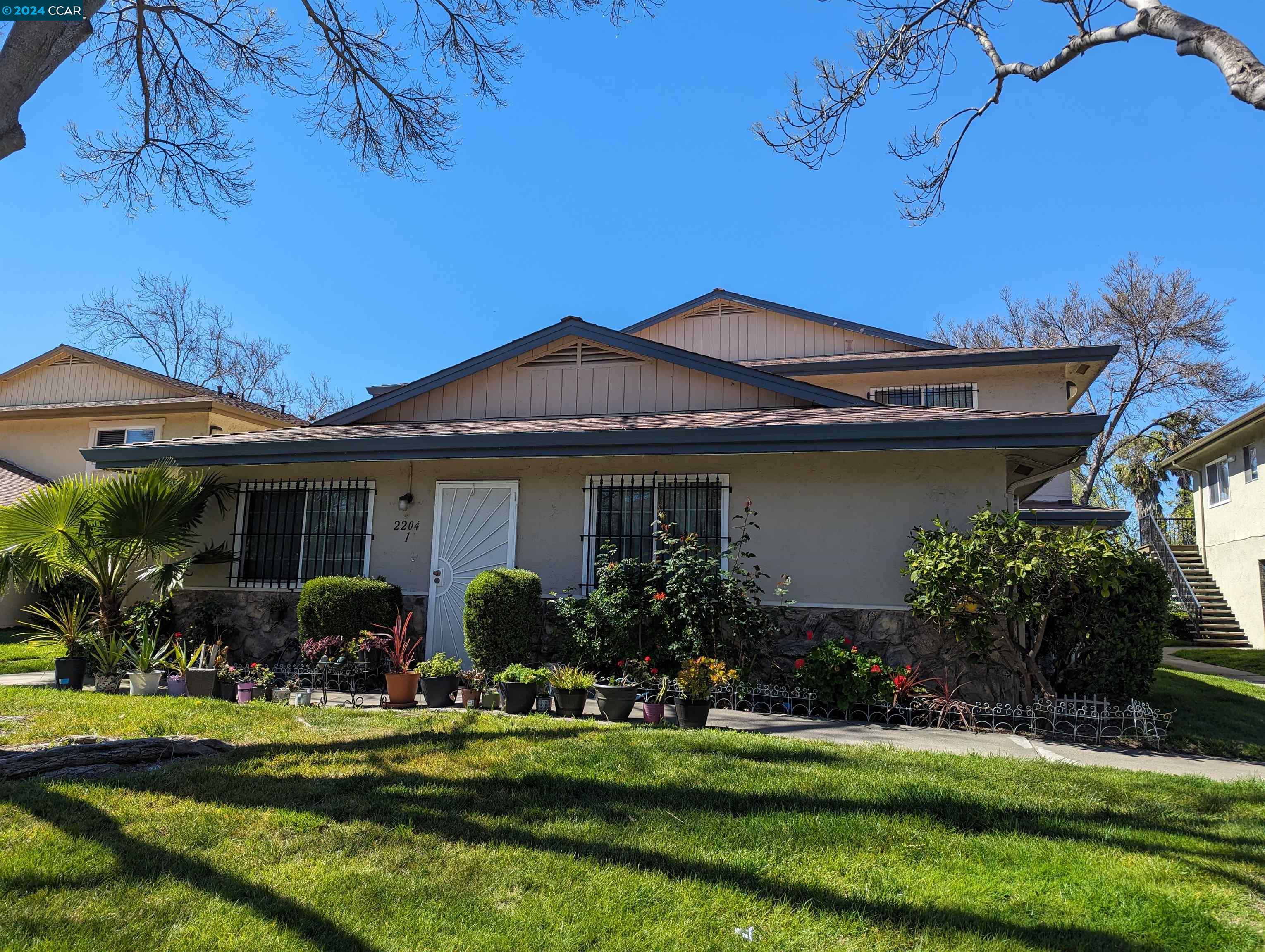 a front view of house with a garden