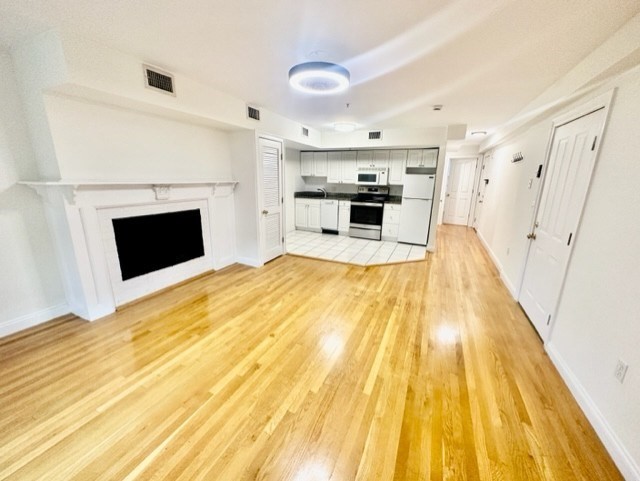 a view of kitchen with furniture and fireplace