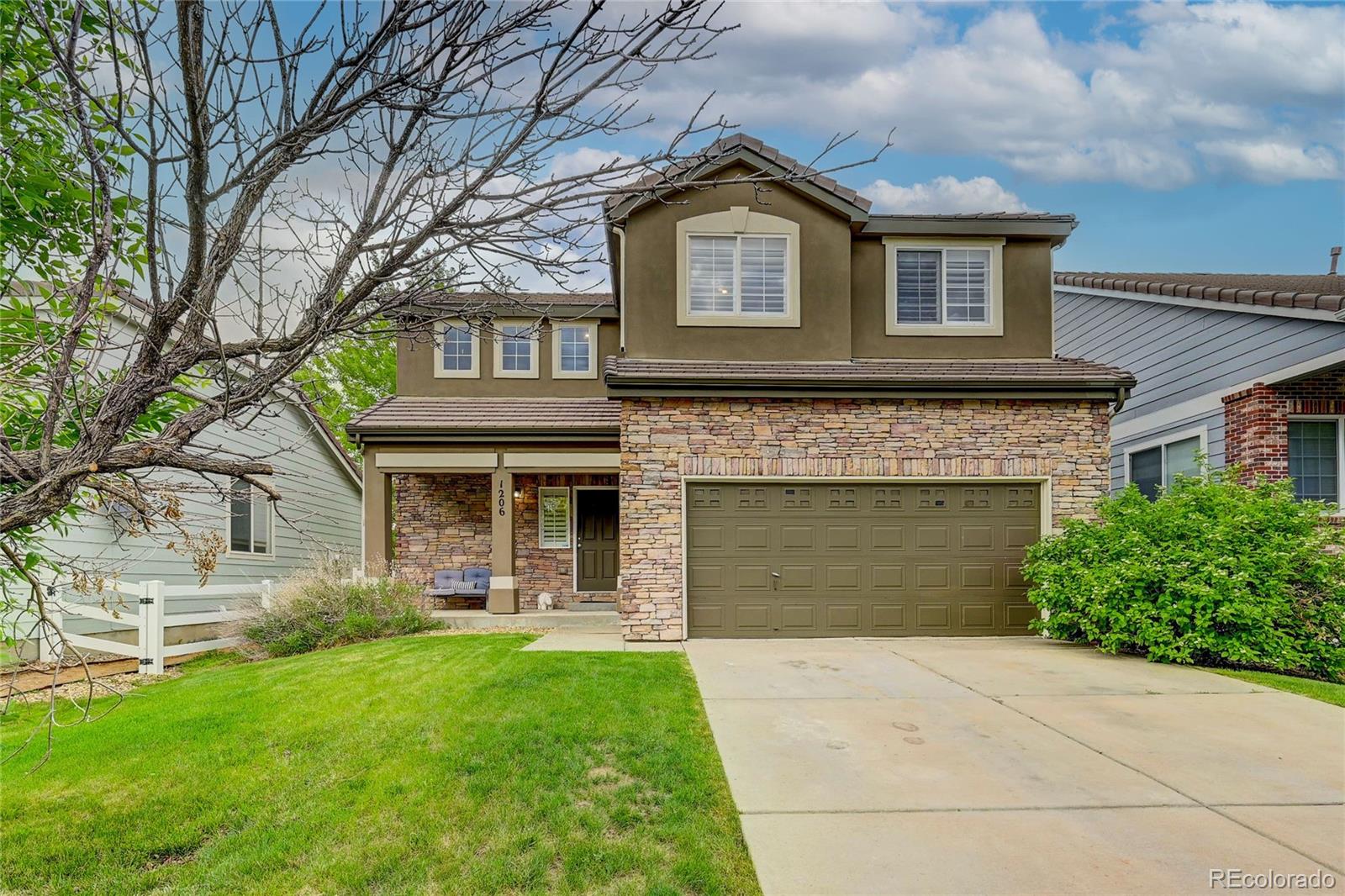 a front view of a house with a yard and garage