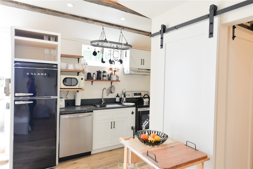 a kitchen with stainless steel appliances granite countertop a sink and cabinets