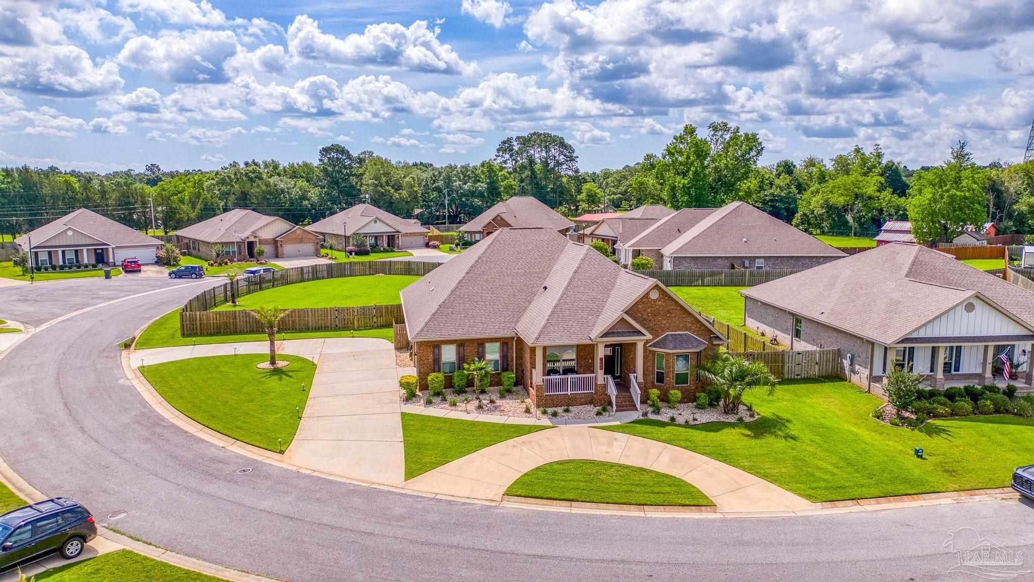 an aerial view of a house with a swimming pool yard and outdoor seating