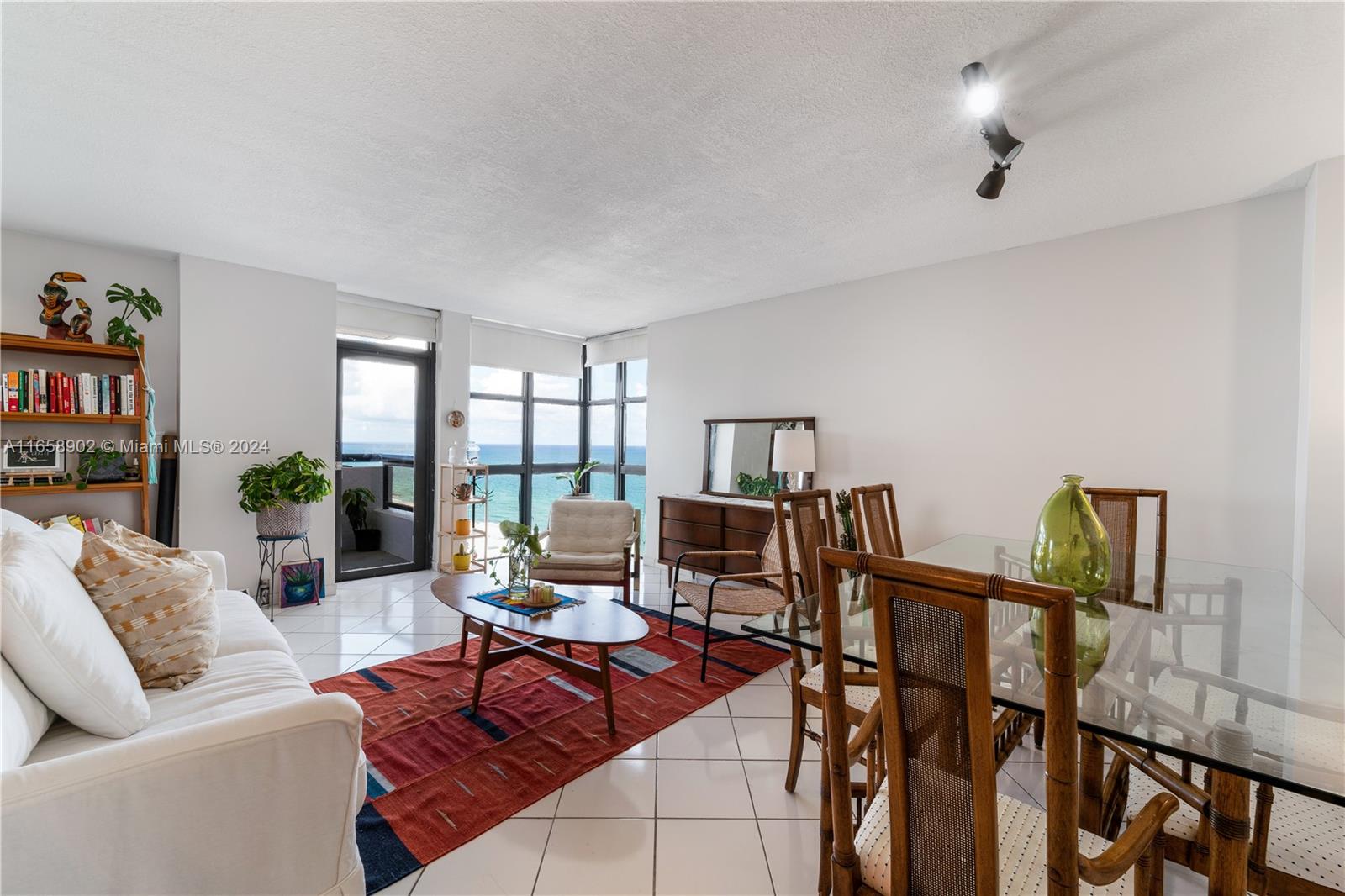 a living room with furniture a rug and a chandelier