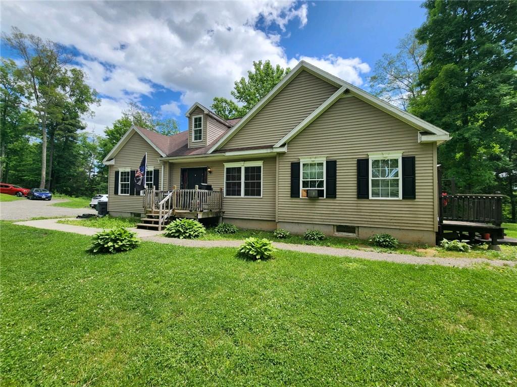 a front view of house with yard and green space