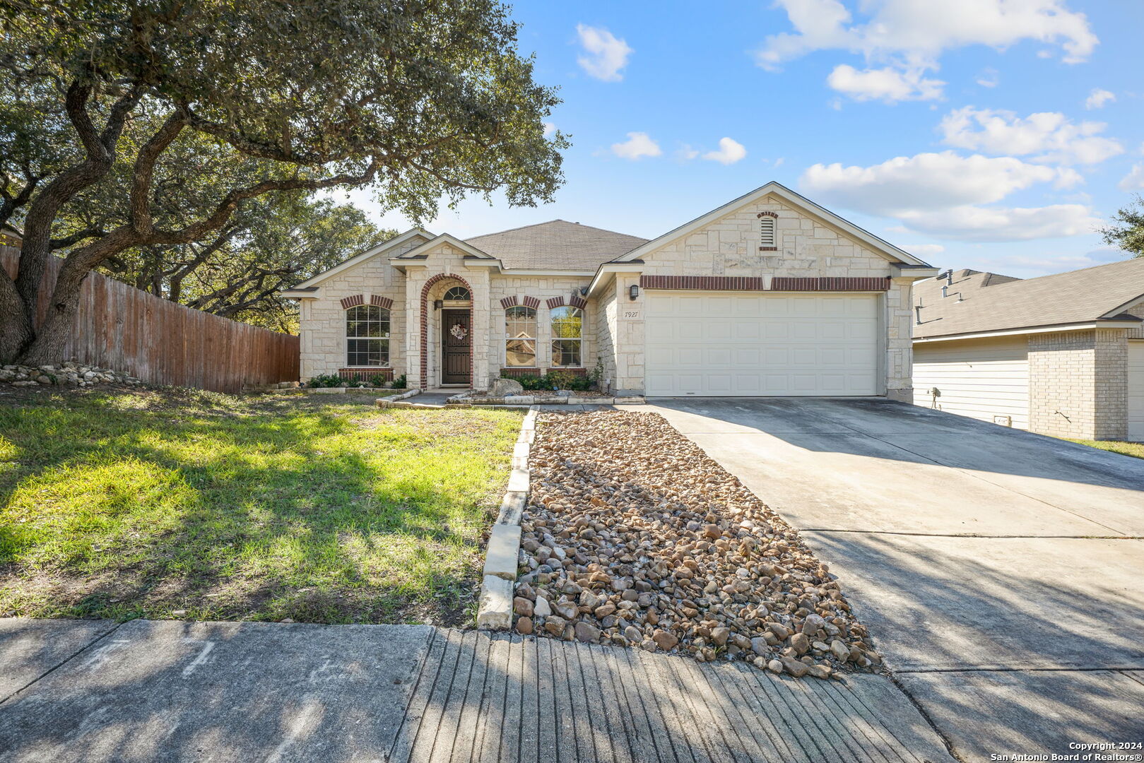 a front view of a house with yard and garage