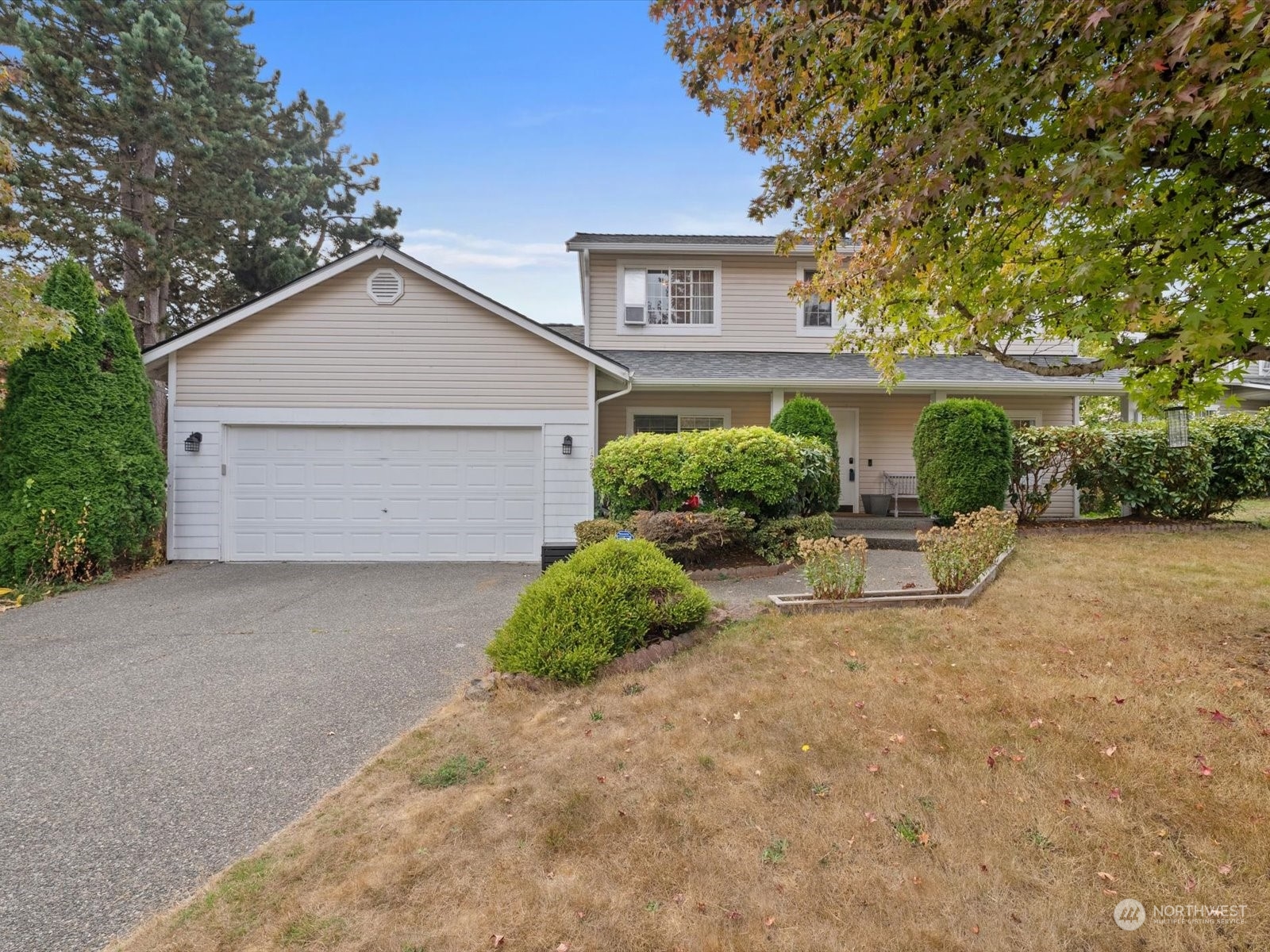 a view of a house with a yard and garage