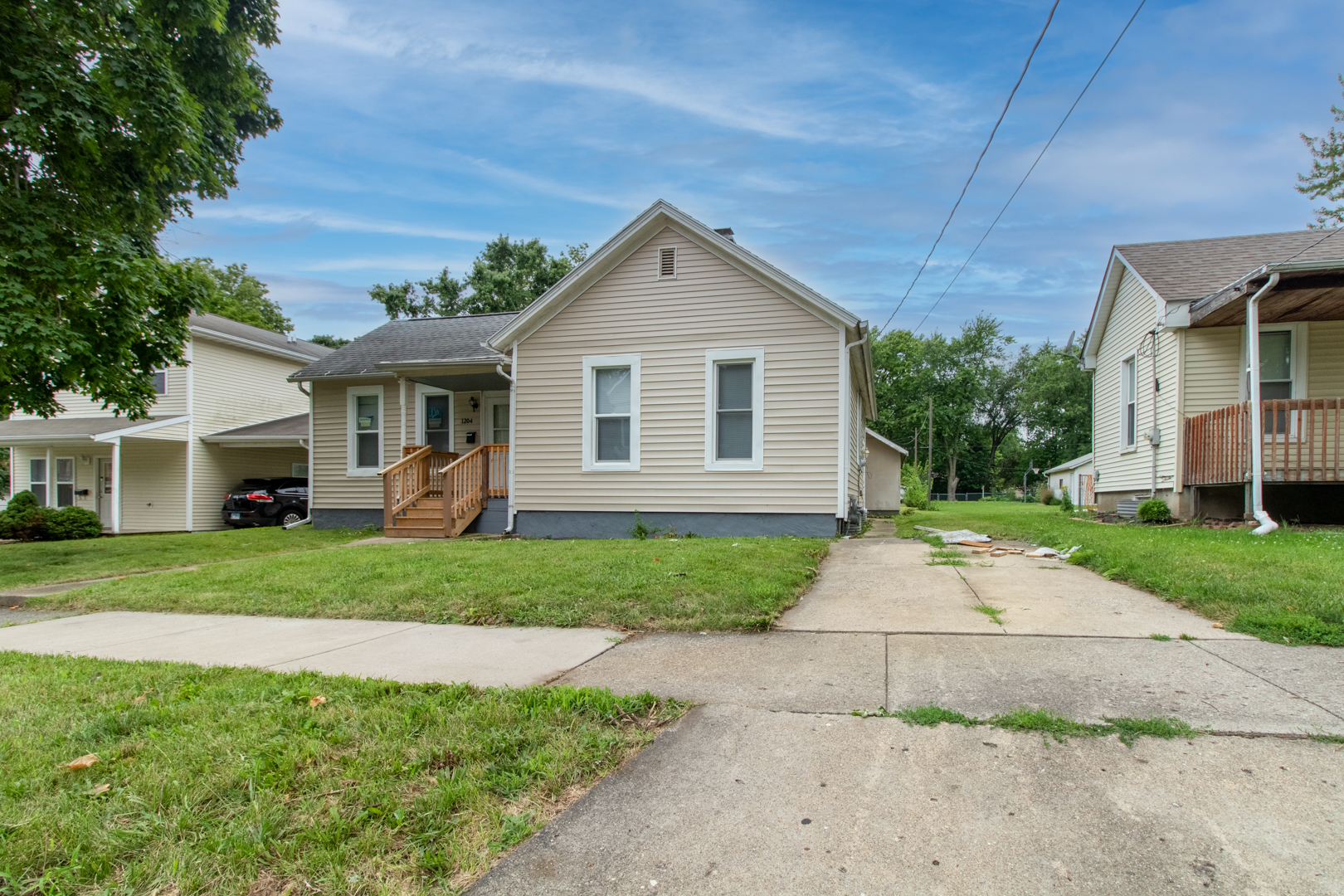 a front view of a house with a yard and trees