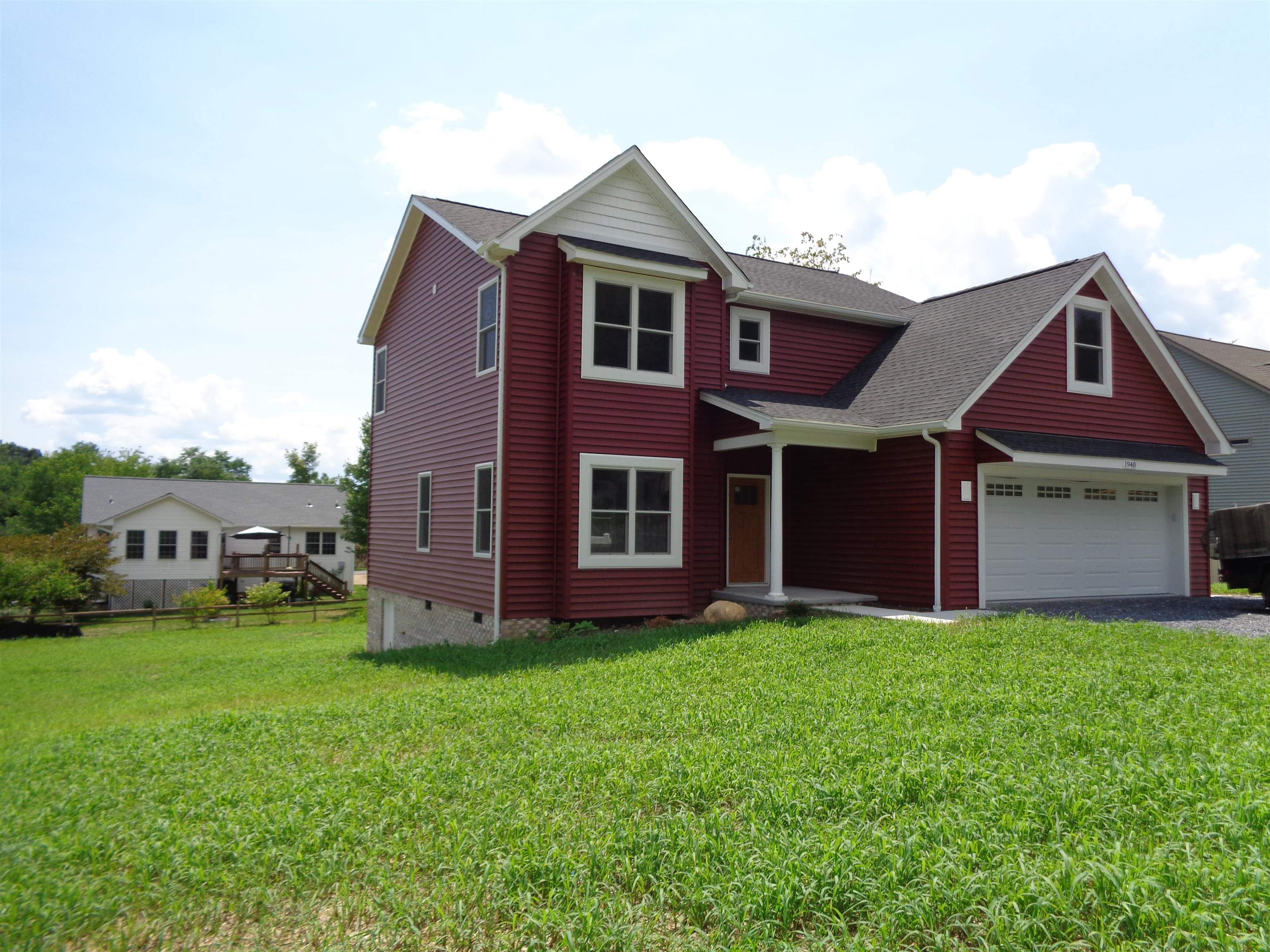 a view of a yard in front of a brick house with a small yard