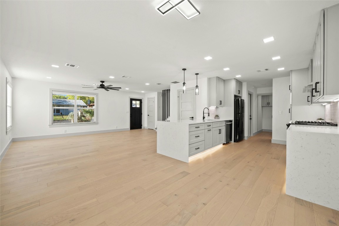 a view of a kitchen with a sink and a refrigerator