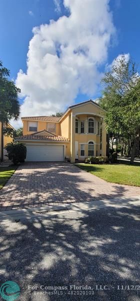 a view of house with yard in front of it