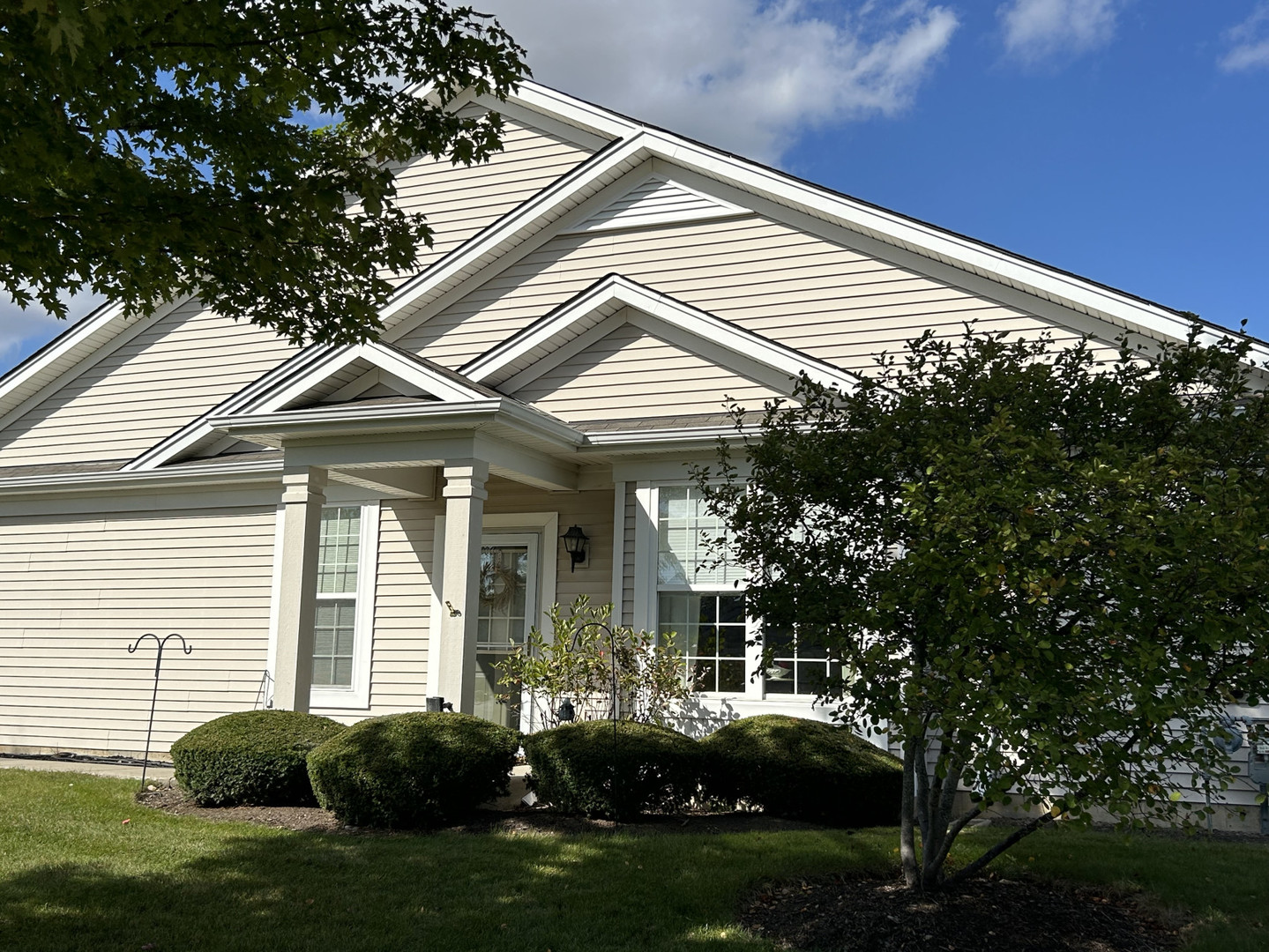 a front view of a house with a garden