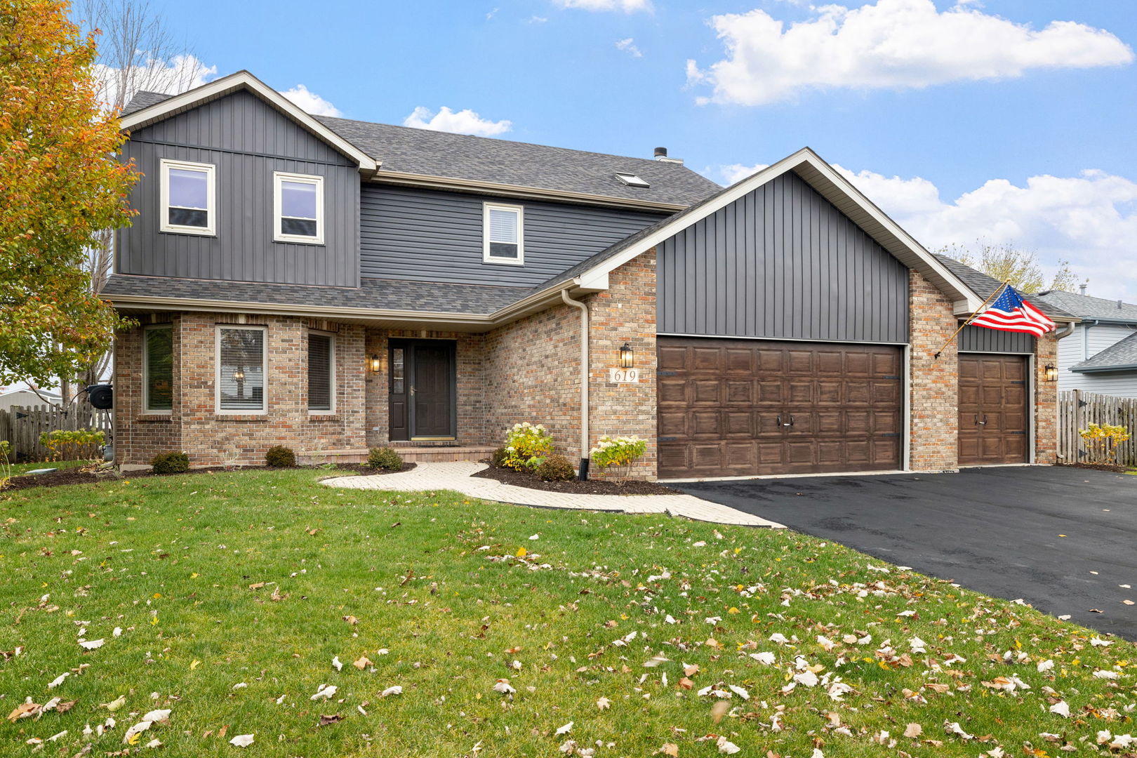 a front view of a house with a yard and garage