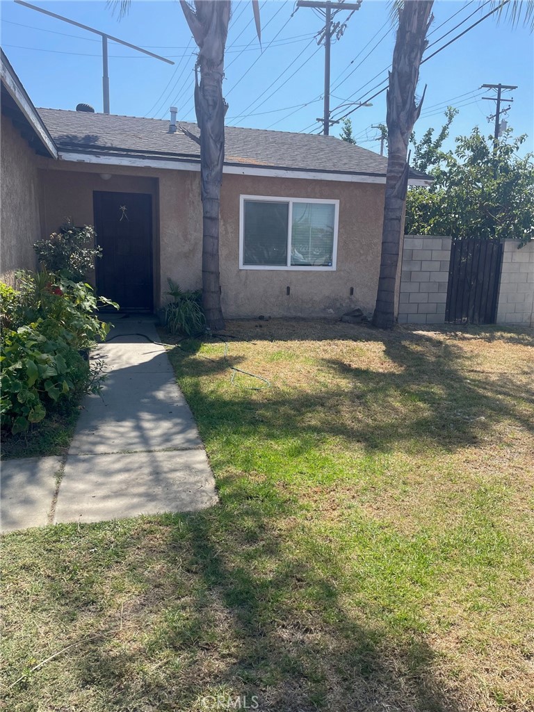 a view of yellow house with a yard