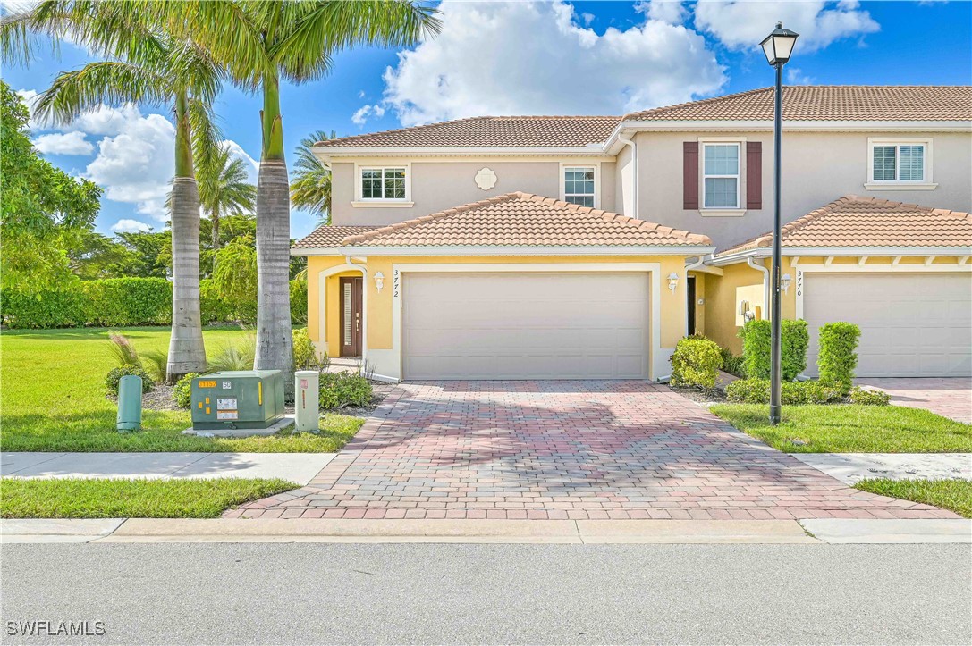 a front view of a house with a garden and yard