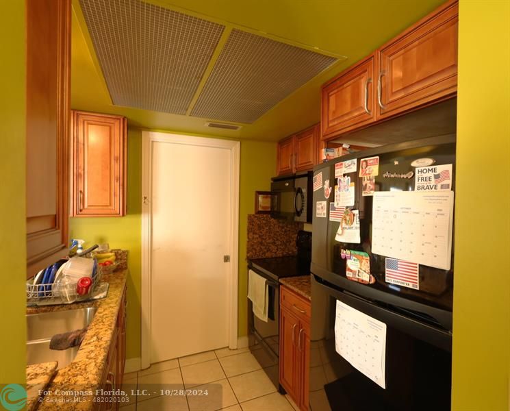 a kitchen with a sink and refrigerator