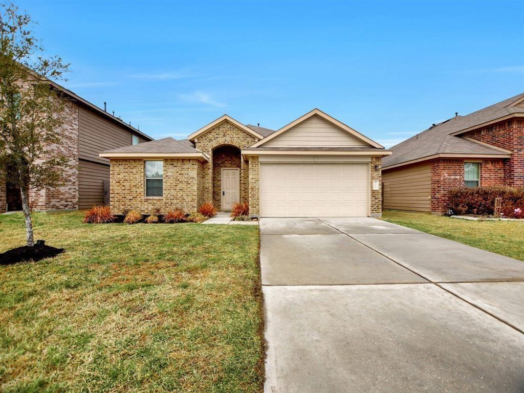 a front view of a house with a yard and garage