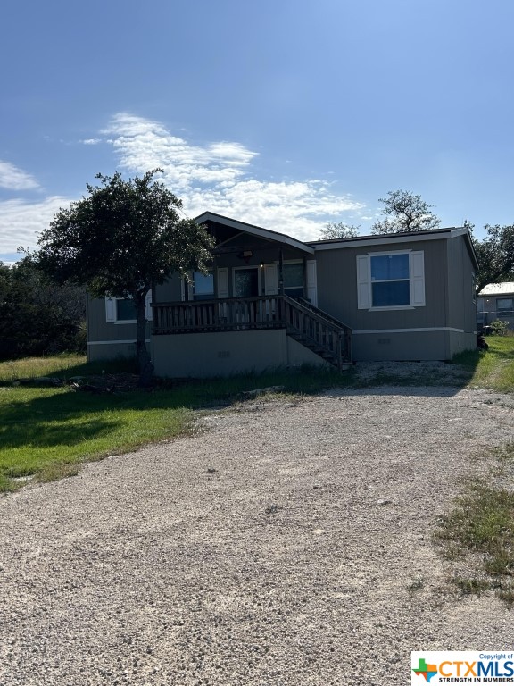 a view of a house with a backyard