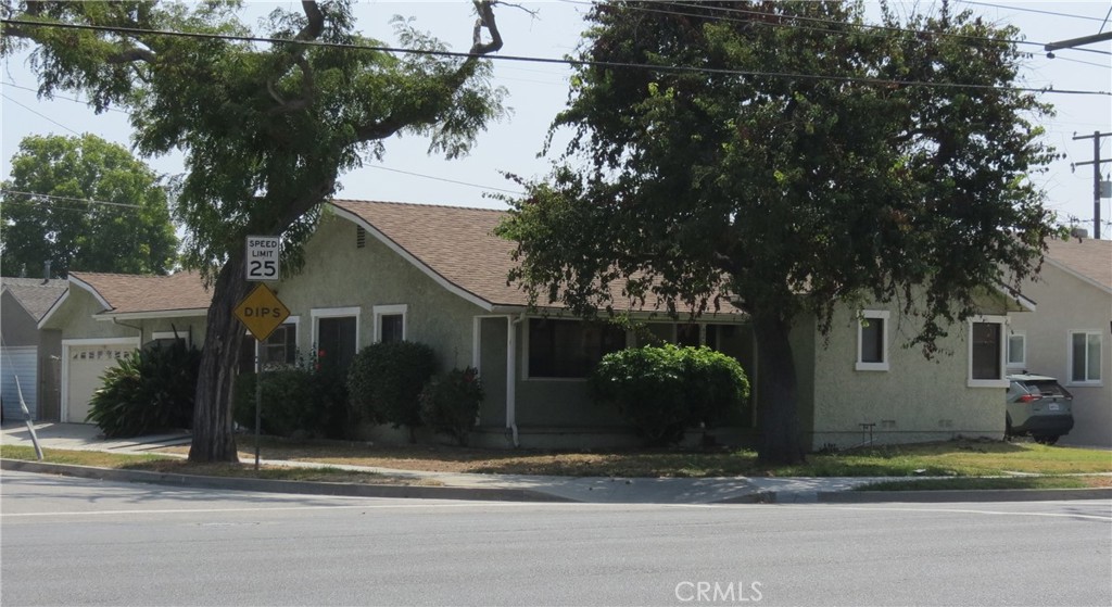 a house that has a tree in front of it