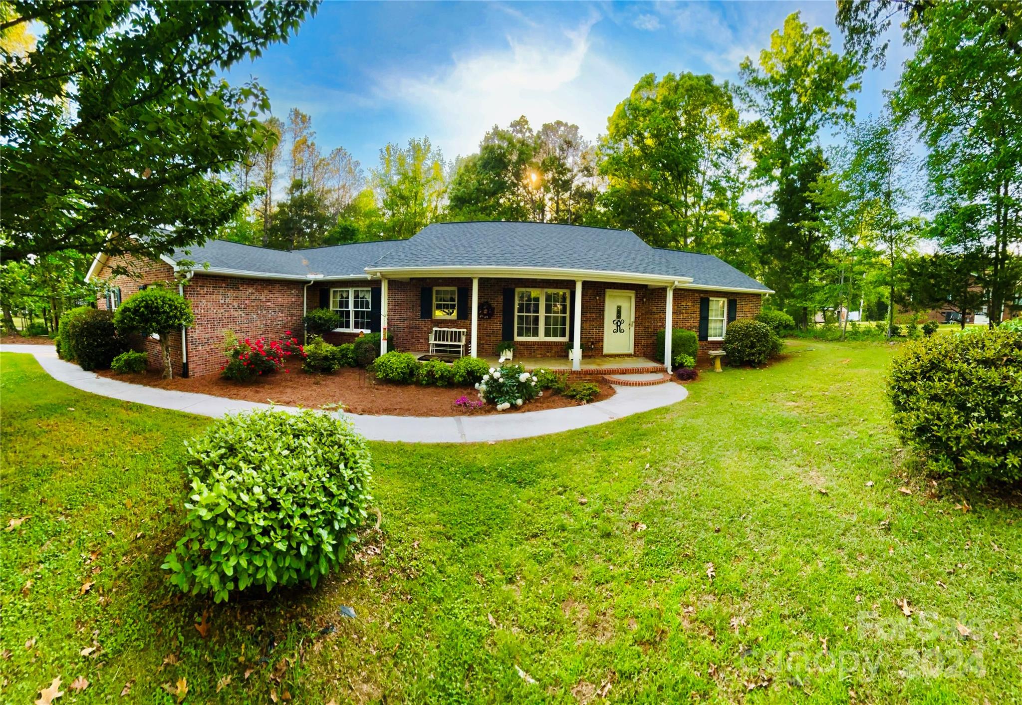 a view of a house with a yard patio and a garden