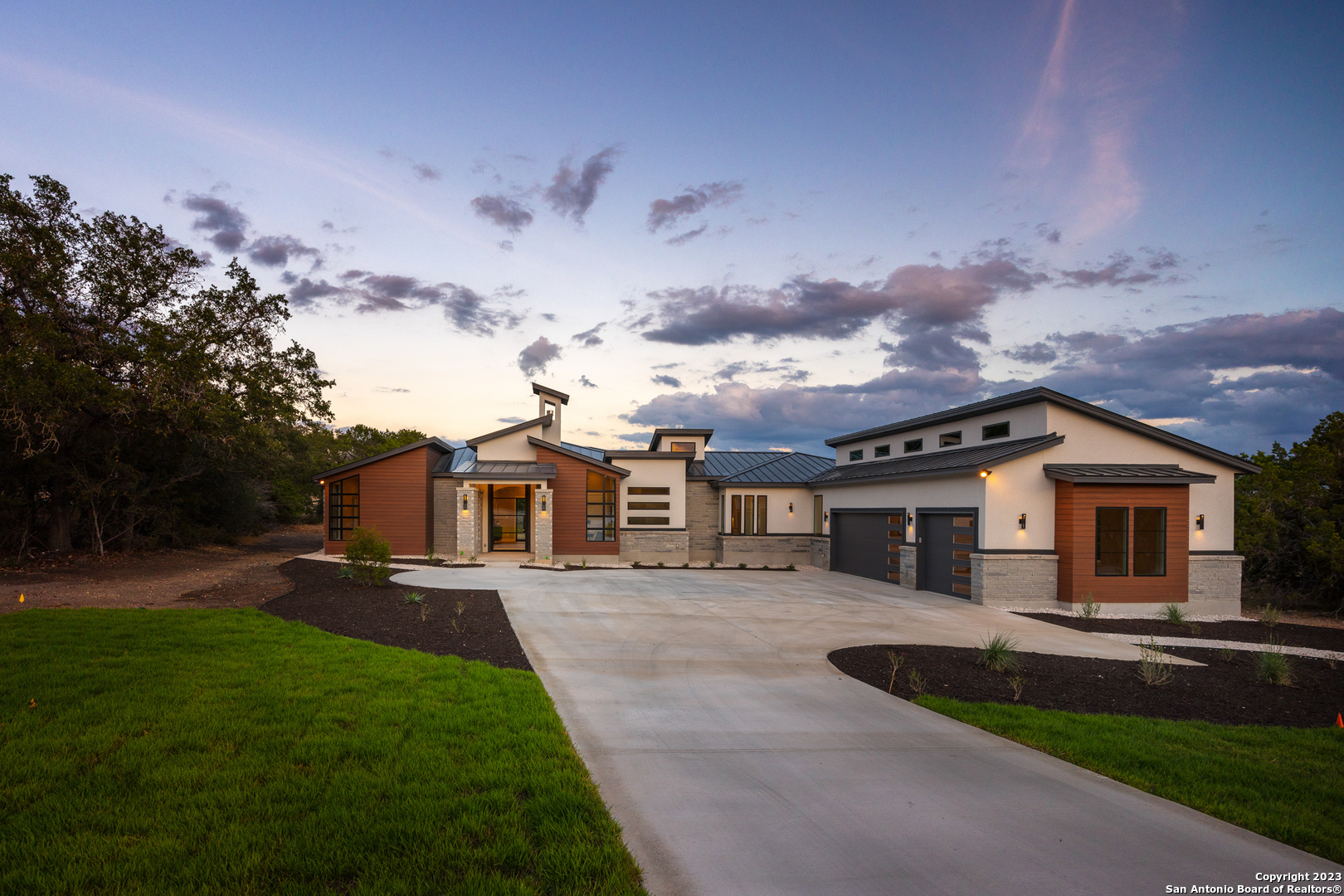 a front view of a house with a yard and garage