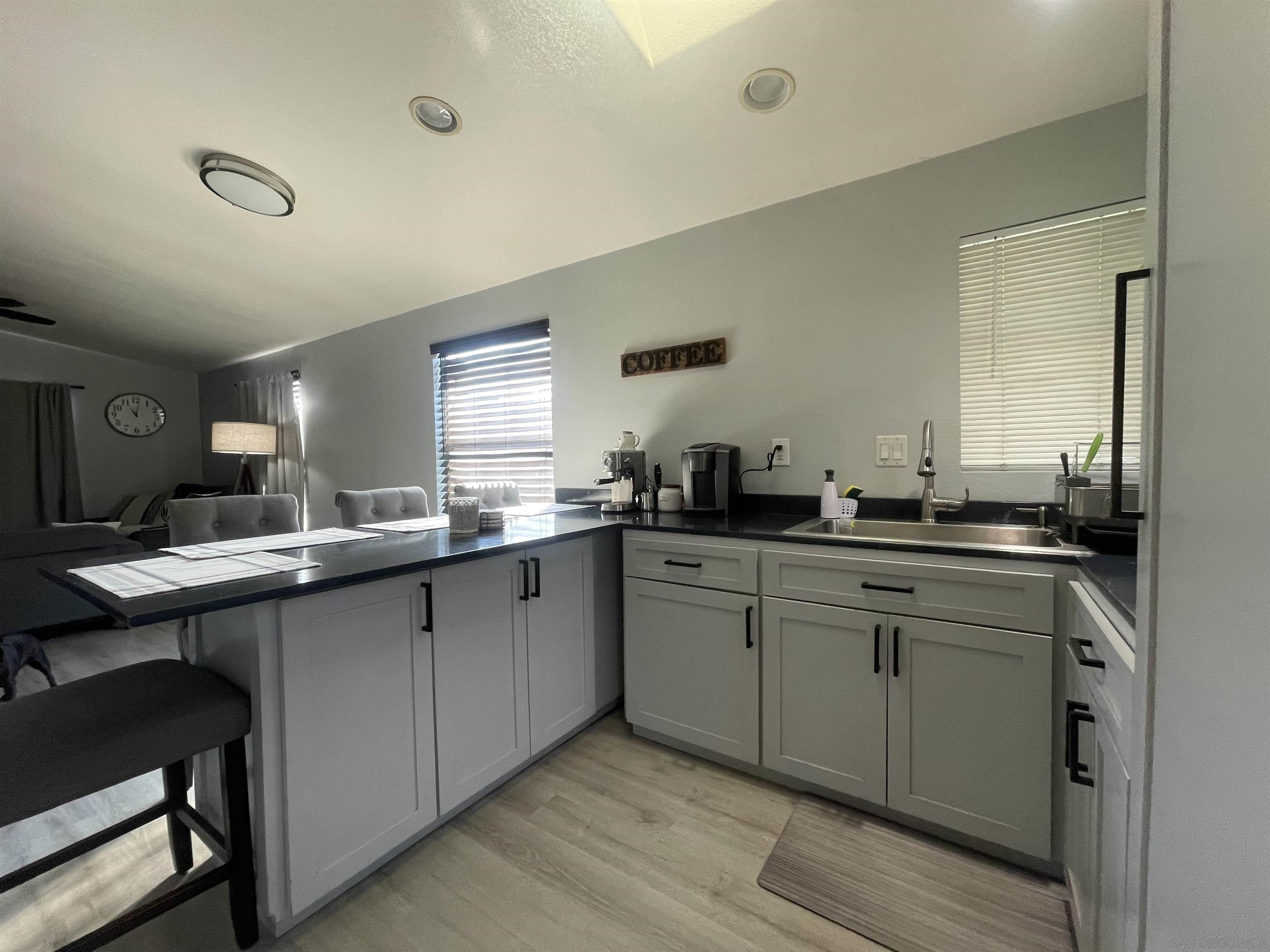 a kitchen with a sink cabinets and window