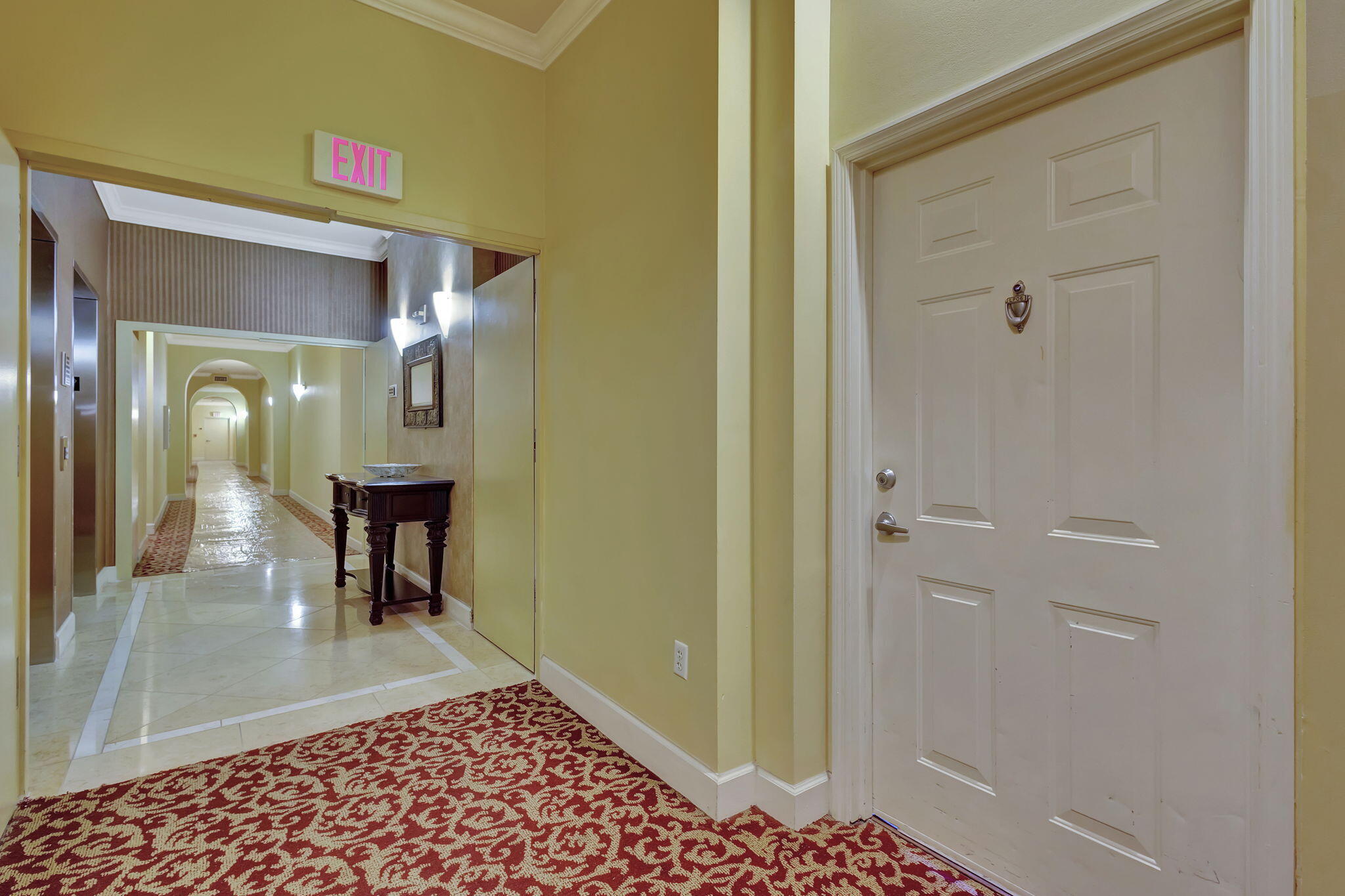 a view of a hallway with a furniture and a livingroom