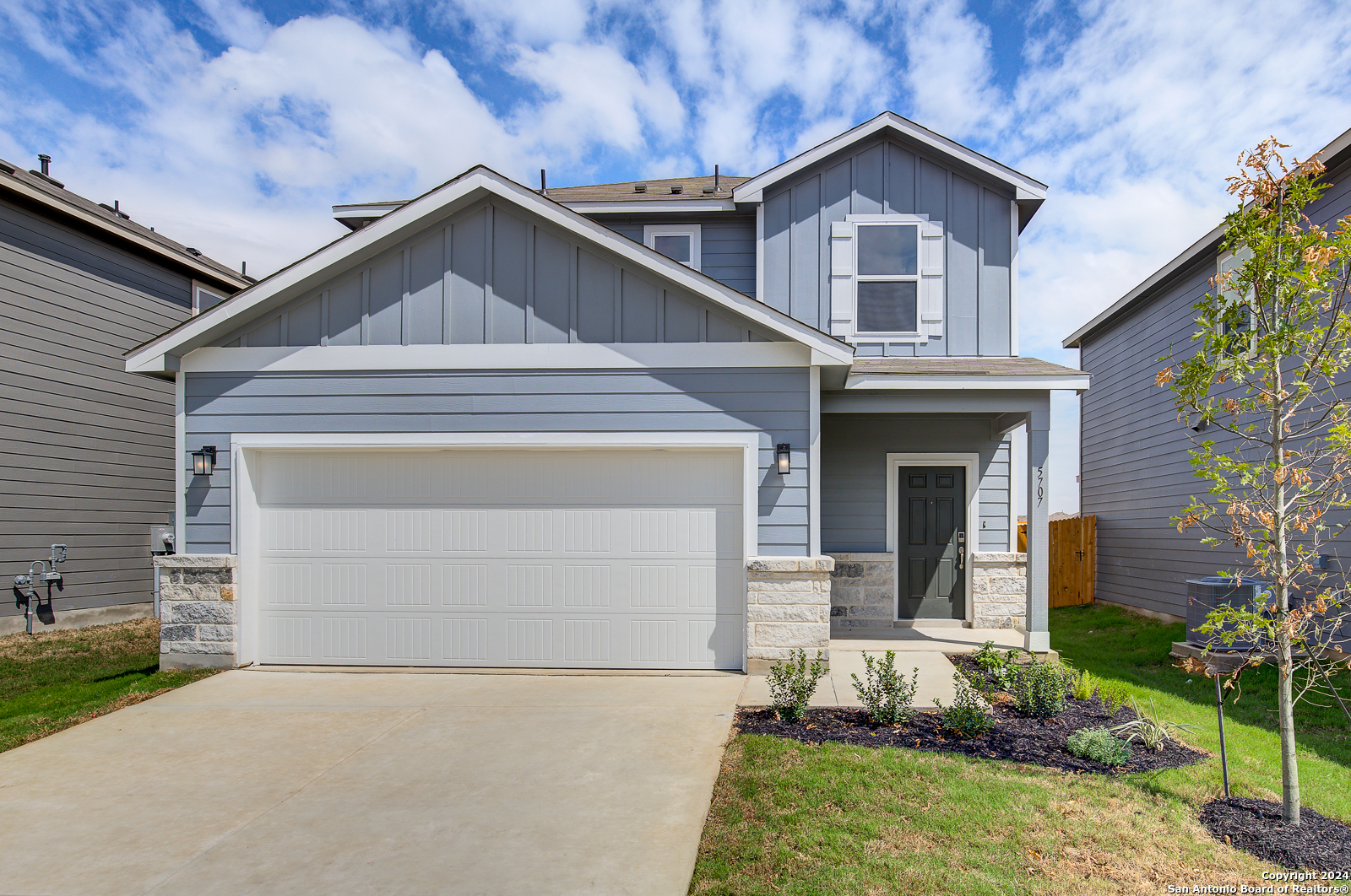 a front view of a house with a yard and garage