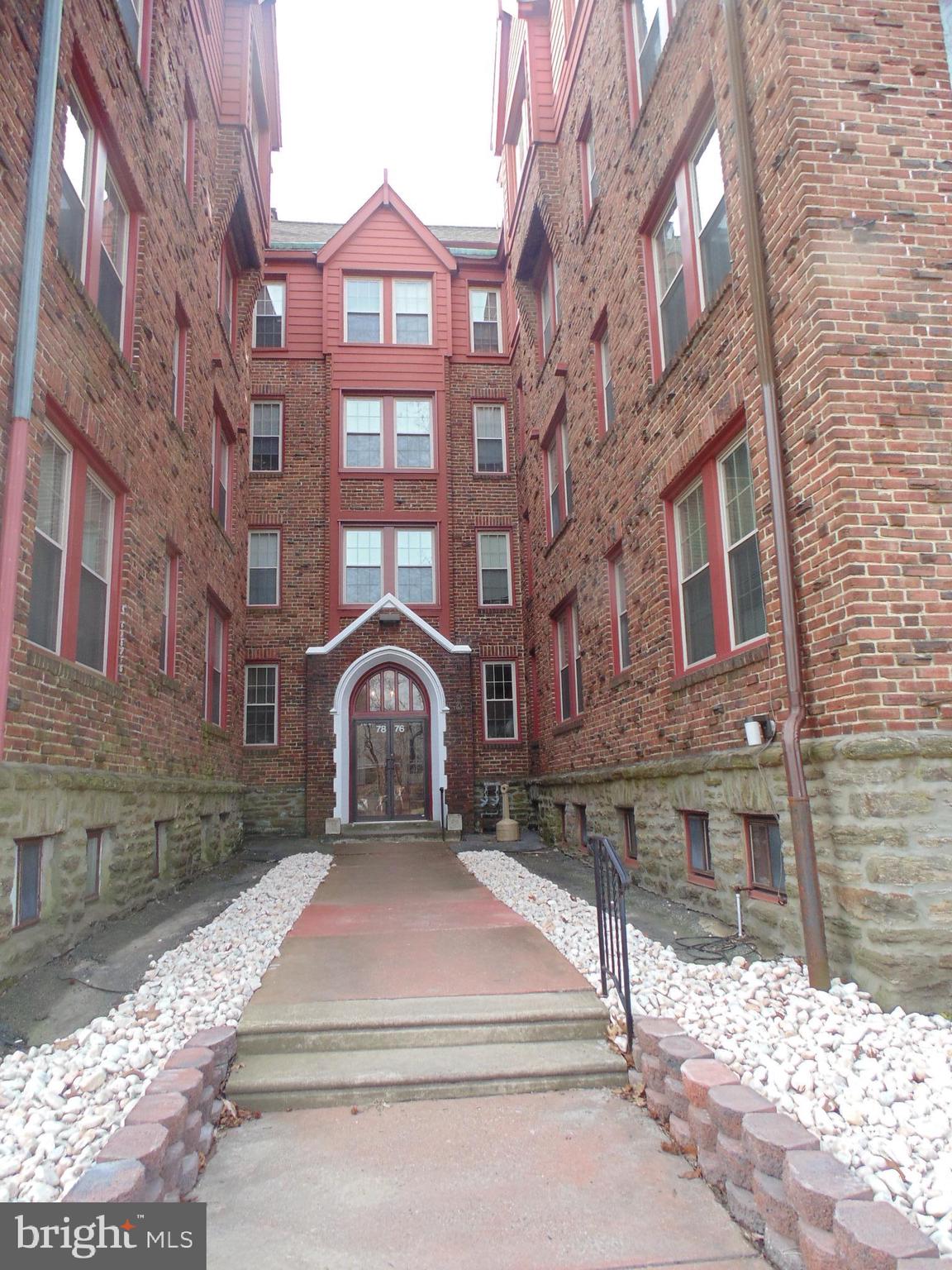 a front view of a building with a yard