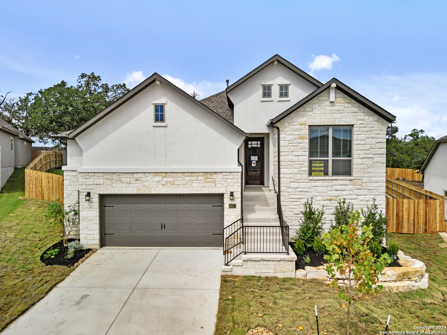 a front view of a house with a yard and garage