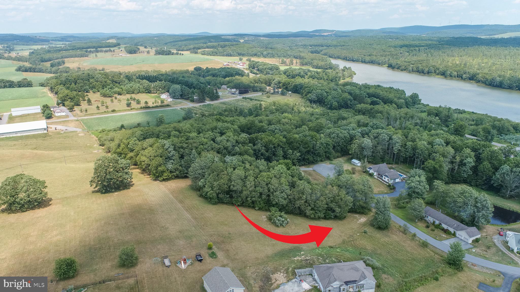 an aerial view of residential houses with outdoor space and river