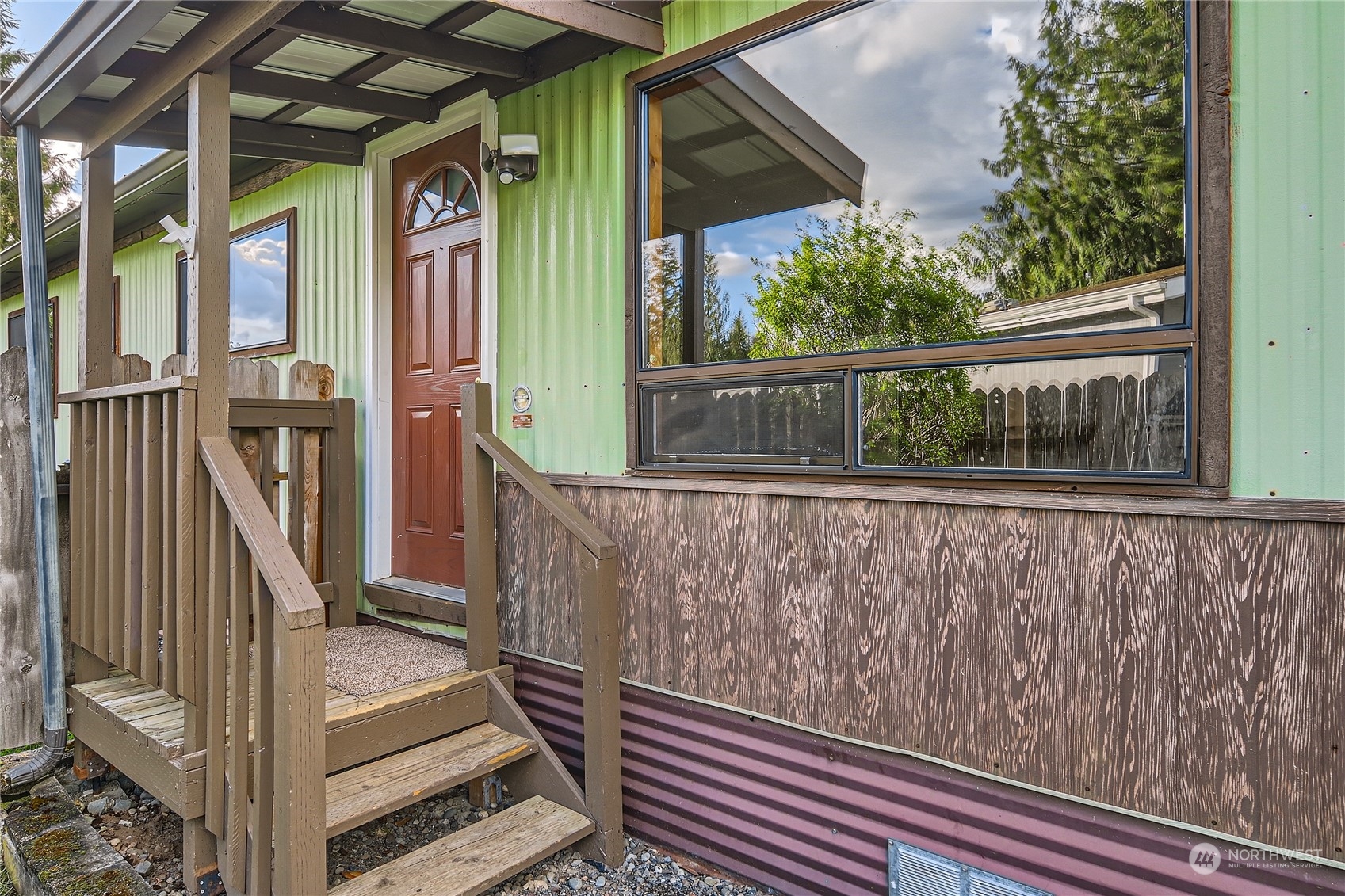 a view of a balcony with wooden floor and outdoor space