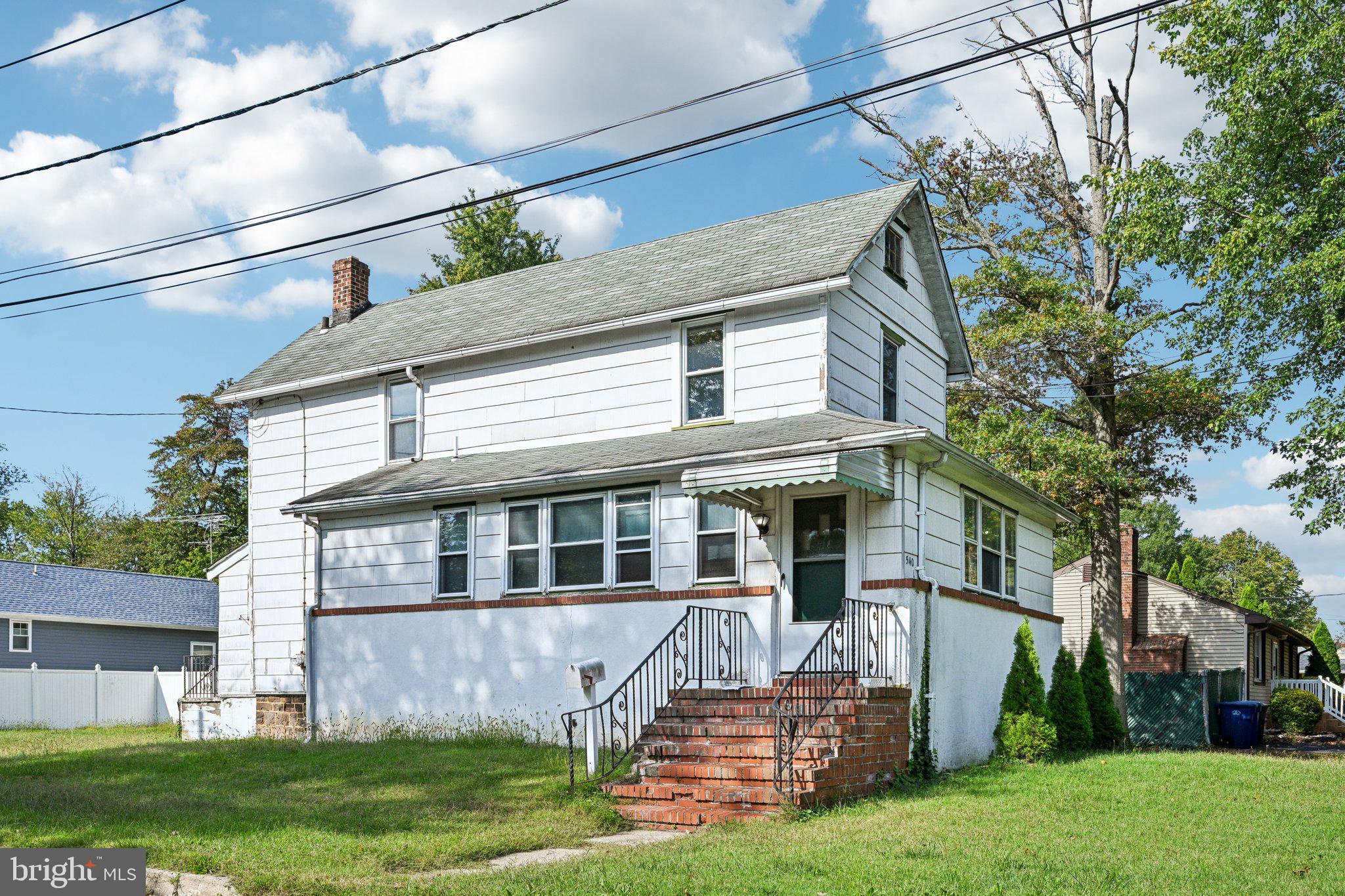 a view of a house with a yard and sitting area