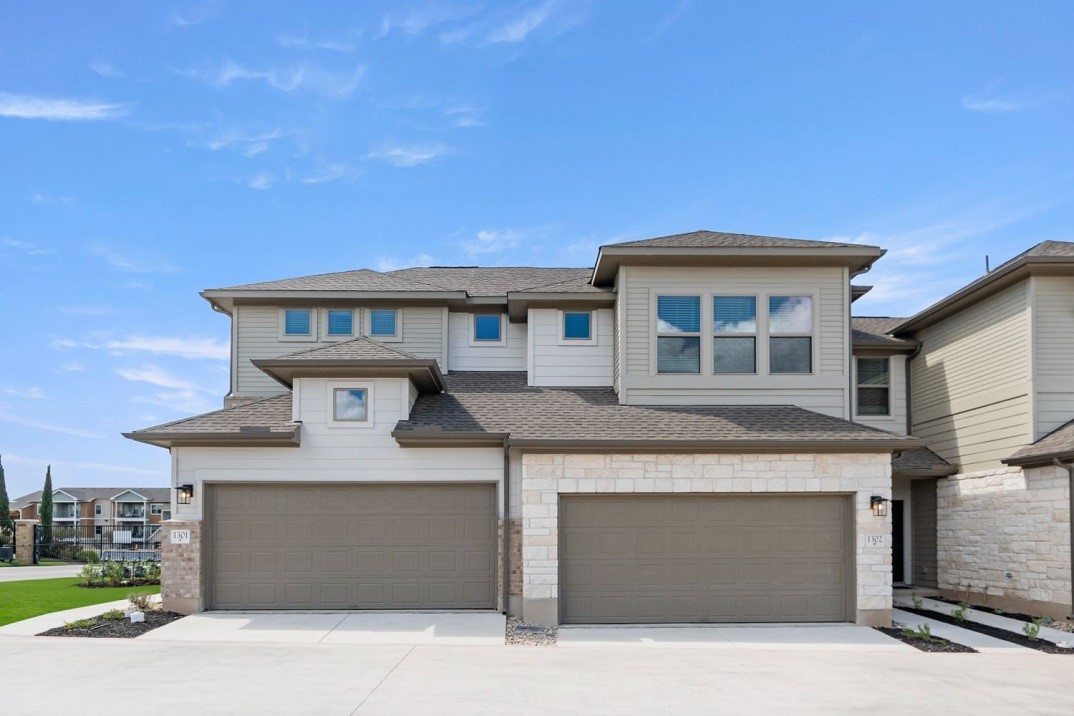 a front view of a house with a garage