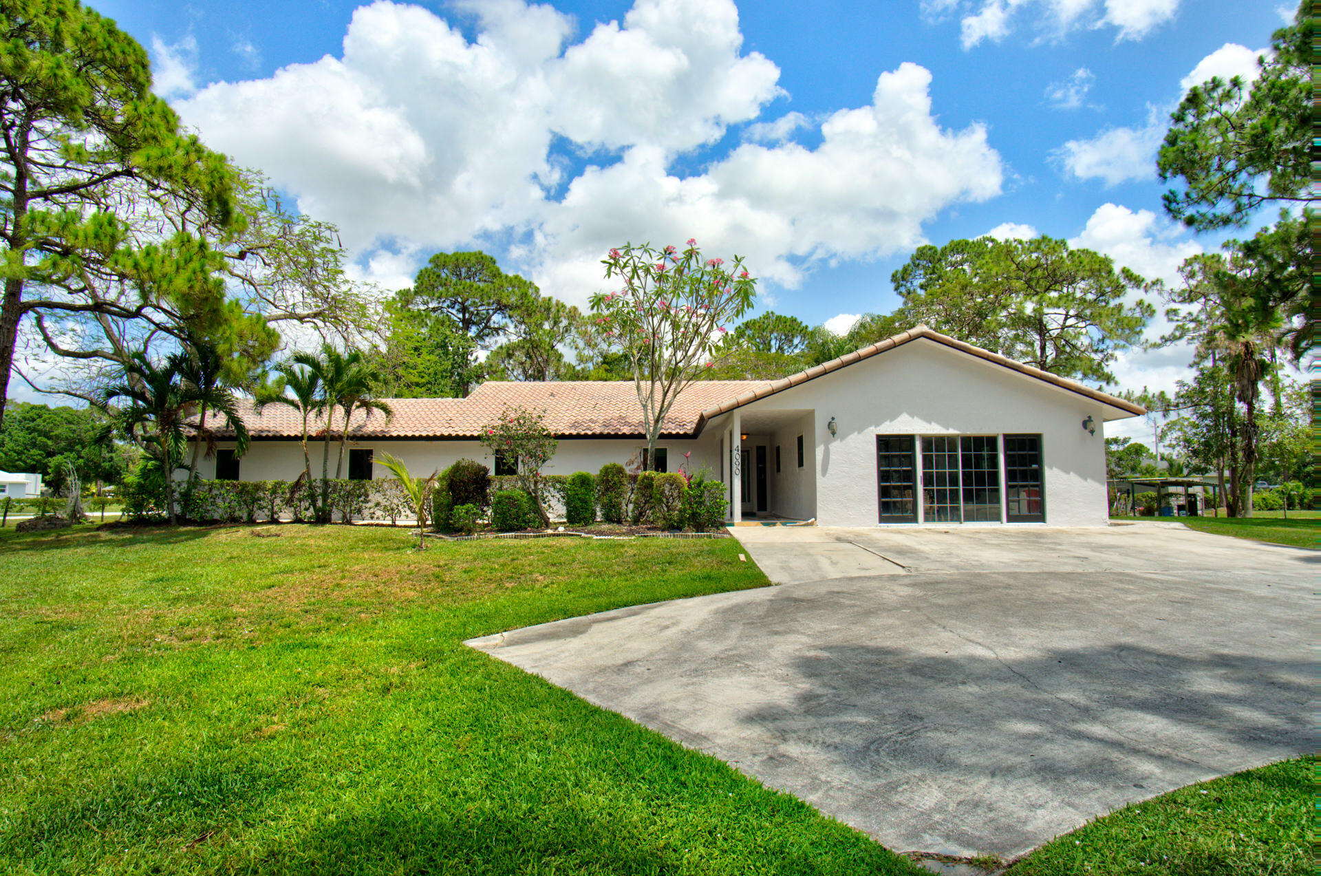 a front view of a house with a yard and trees