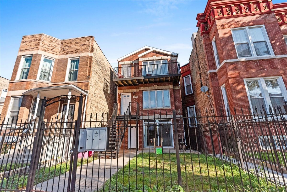 a view of a brick building next to a yard