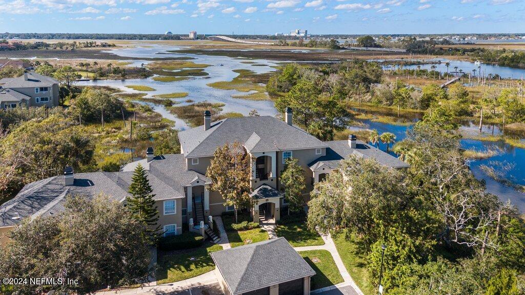 an aerial view of residential houses with outdoor space and swimming pool