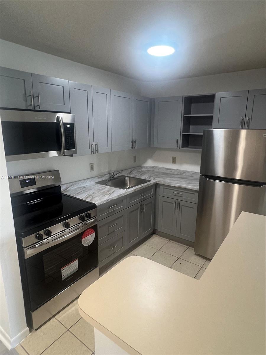 a kitchen with a sink a stove and refrigerator