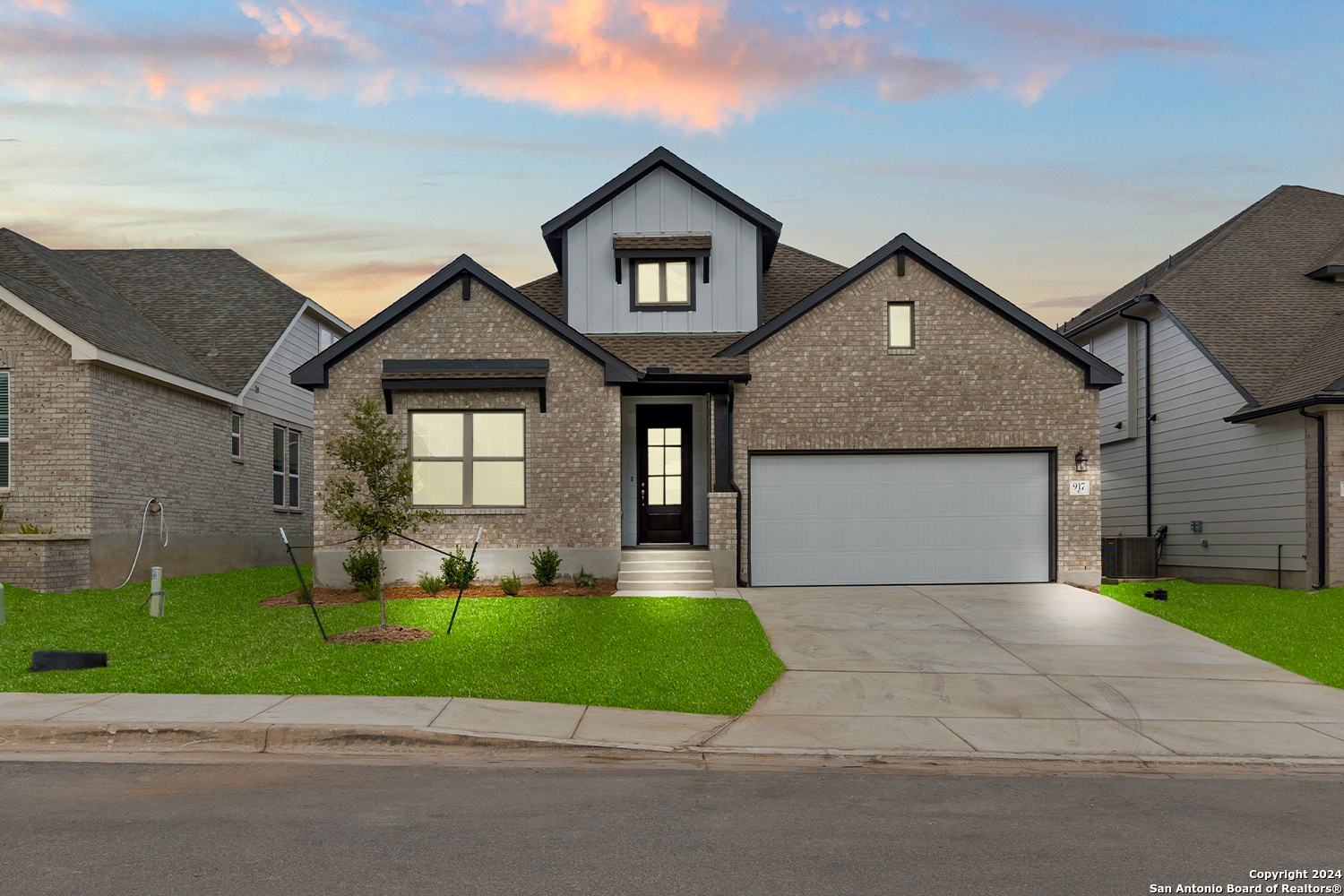 a front view of a house with a garden and yard