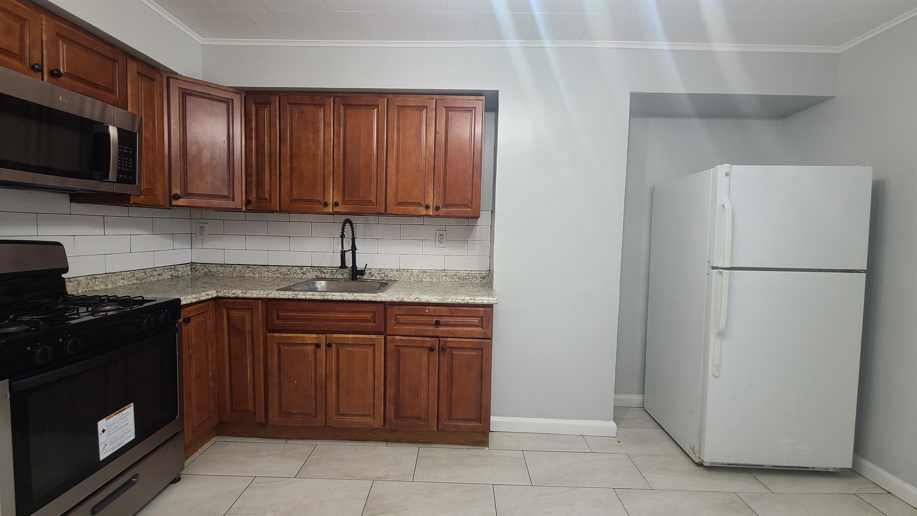 a kitchen with a sink and a refrigerator