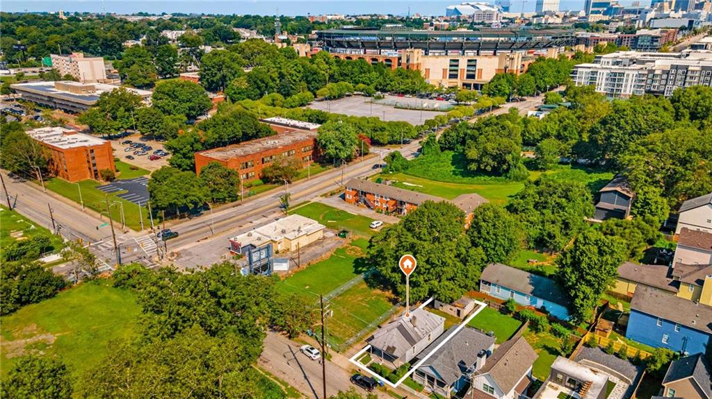 an aerial view of residential houses with outdoor space and swimming pool