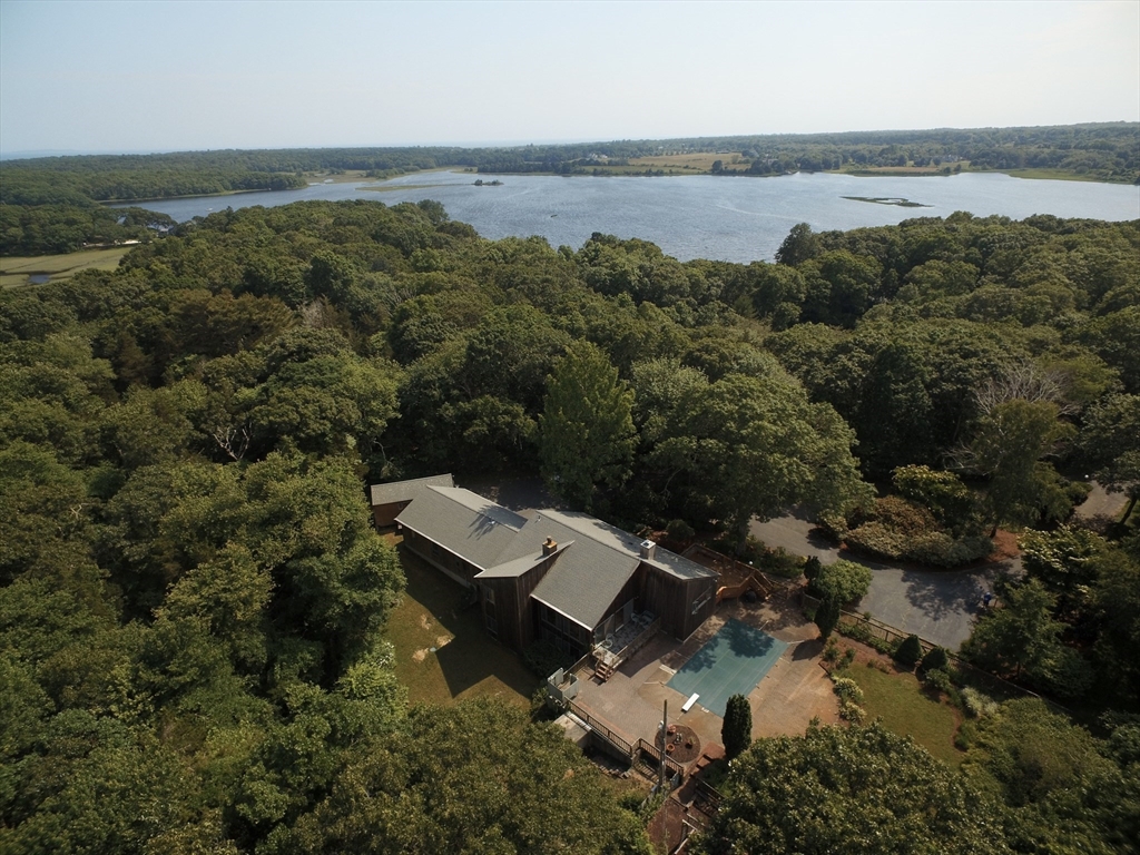 an aerial view of a house with a yard and lake view