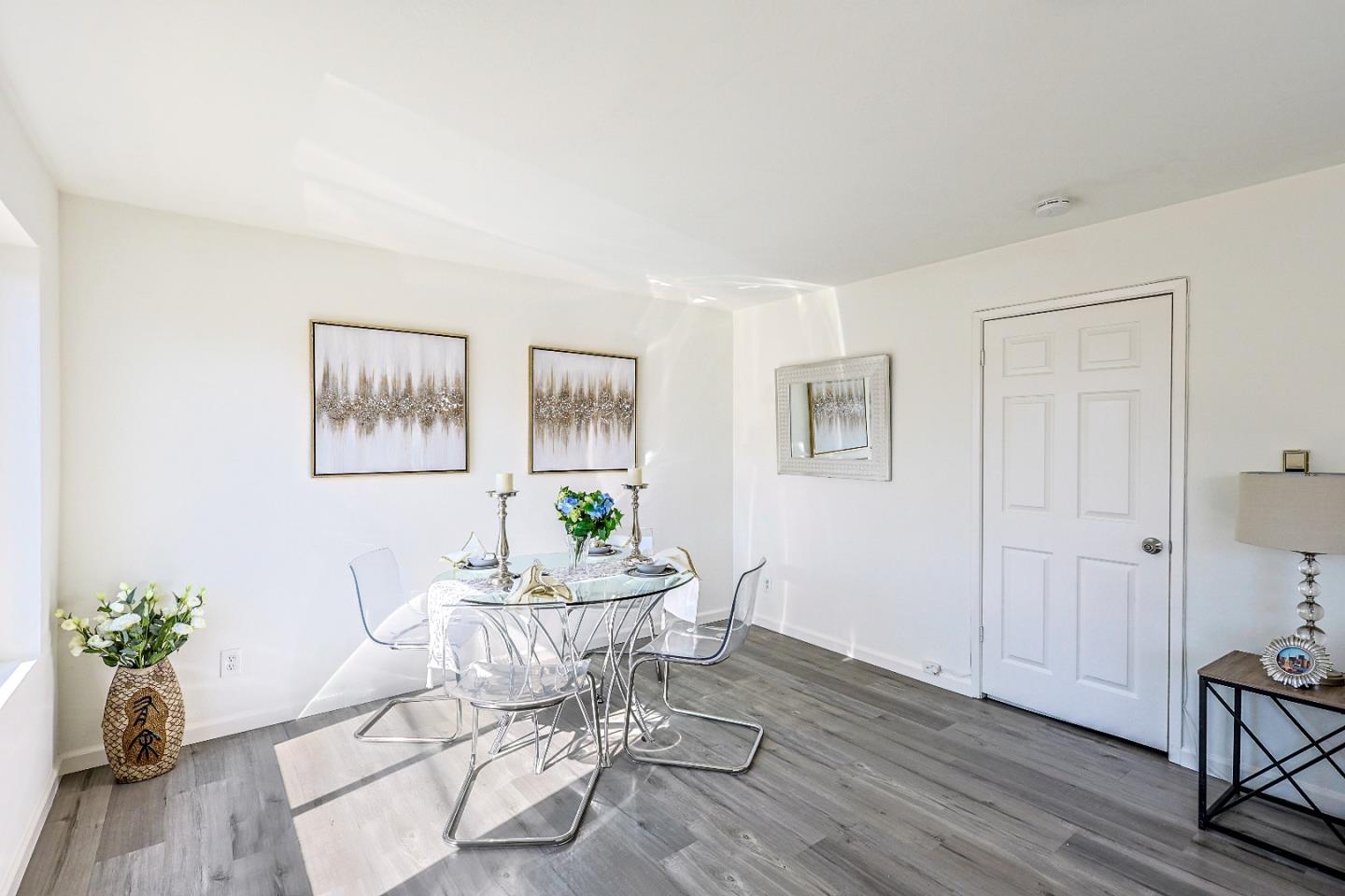 a dining room with furniture and wooden floor