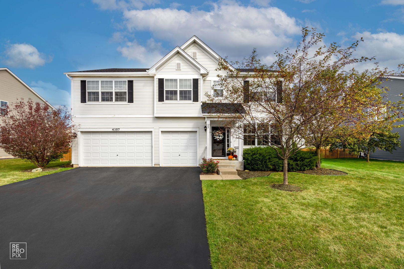 a view of a house with a yard and garage