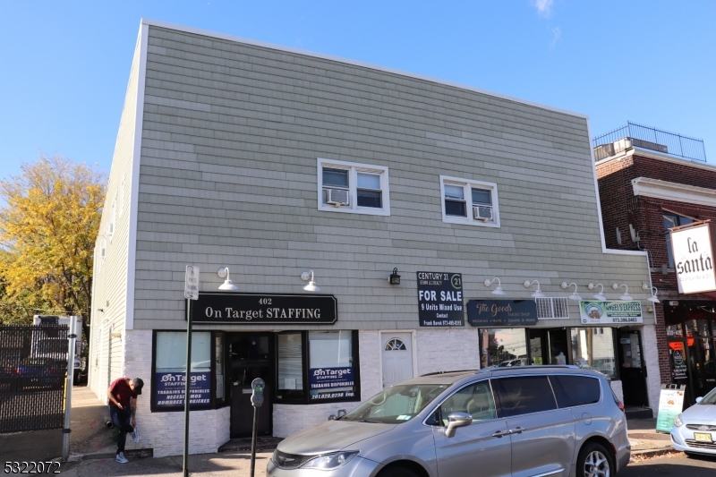 a front view of a building with parking space