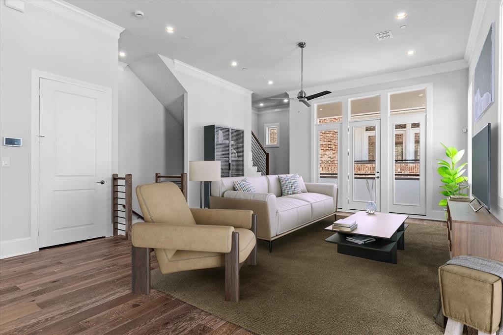 a living room with furniture ceiling fan and a rug