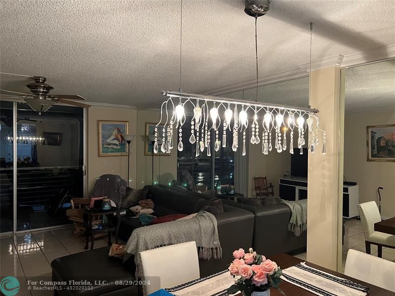 a living room with furniture and a chandelier